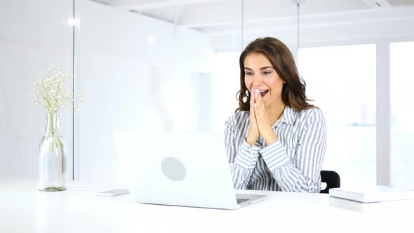 Happy Hispanic Woman Celebrating Success of Her Project