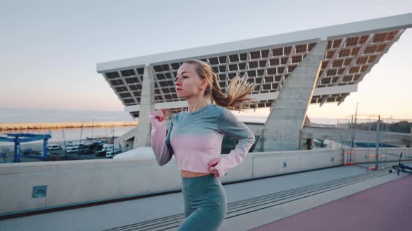 Attractive Millennial Female Athlete Enjoy Morning Run By Pedestrian Bridge