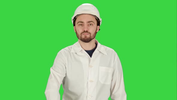 Man in the Construction Helmet with a Raised Finger on a Green Screen, Chroma Key