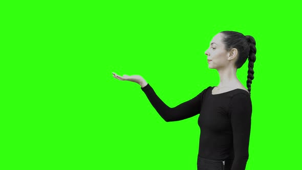 Young Woman Walking and Stoping to Communicate With a Virtual Entity Green Screen.