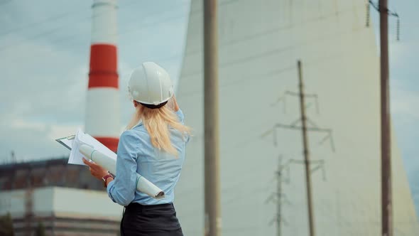 Technician On High Voltage Wire Line. Worker On Energy Transmission Tower. Distribution Station.