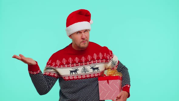 Man in Christmas Sweater Pointing at Camera Showing Stupid Gesture Blaming Some Idiot for Plan