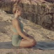 Blond Young Caucasian Female Yoga Teacher Meditating in the Mountains Near the Sea - VideoHive Item for Sale