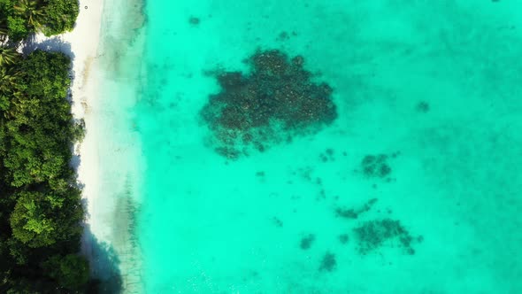 Wide angle drone clean view of a white sand paradise beach and turquoise sea background in hi res 4K