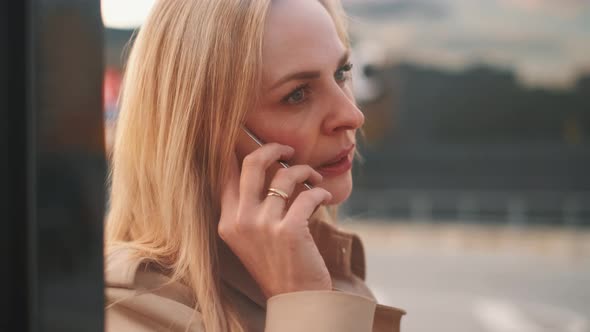 Young Charming Woman Is Calling with Mobile Phone.