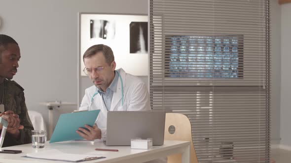 Radiologist Talking to Army Officer with Walking Stick alt
