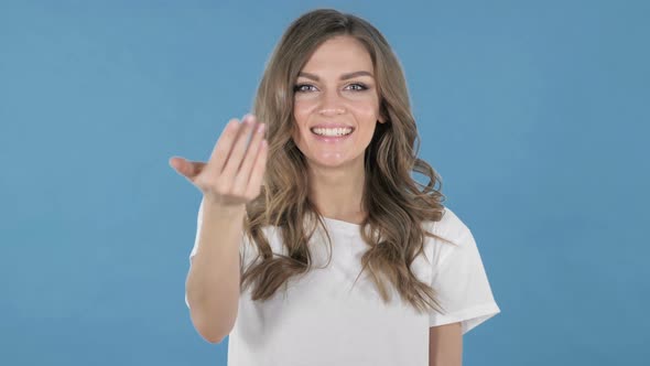 Young Girl Inviting Customers with Both Hands Isolated on Blue Background