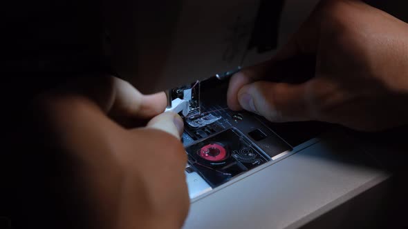 Sewing Machine. Thread in needle. Close-up of sewing machine needle. The tailor sews towel. process