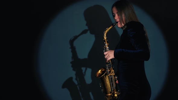 Woman Plays on Saxophone. Musical Concept