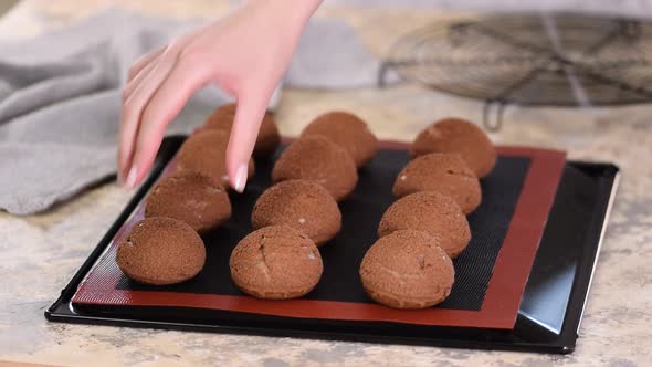 Freshly Baked Chocolate Profiteroles on Baking Sheet