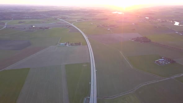 Aerial view of freeway intersection with moving traffic cars.