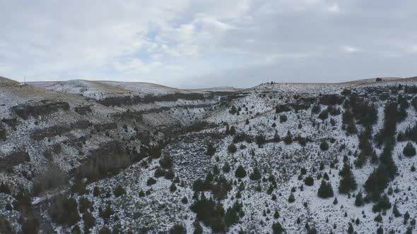 Slow drone tracking through snowy canyon