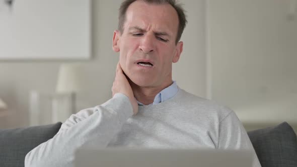 Portrait of Middle Aged Businessman Having Neck Pain at Home