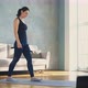 Pretty Woman in Dark Tracksuit with Dumbbells in Living Room - VideoHive Item for Sale