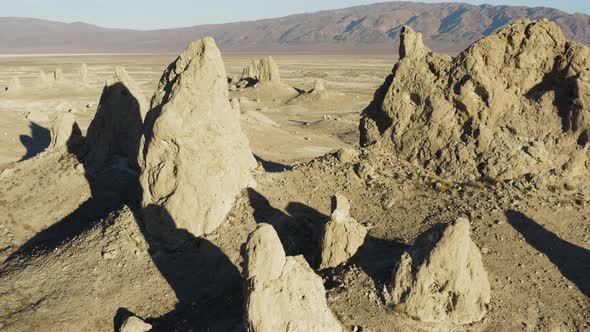 Wide Retreating Aerial shot of the Pinnacles at sunrise in the california desert