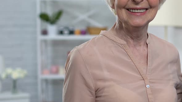 Aged Smiling Woman Showing Thumbs-Ups to Camera, Satisfied With Health Insurance