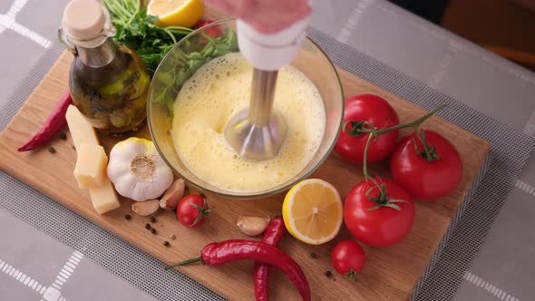 Making Caesar Salad Sauce  Mixing Egg Yolk in Glass Bowl with Blender