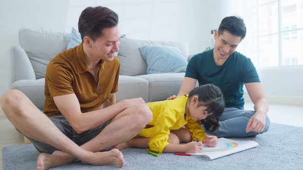 Asian attractive LGBTQ gay family teach young girl kid draw picture and coloring book in living room