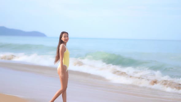 Asian woman enjoy around beautiful beach sea ocean