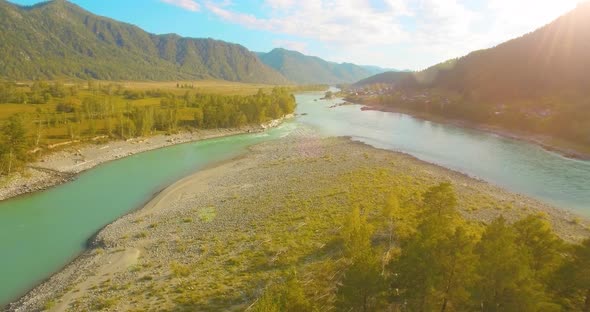 Low Altitude Flight Over Fresh Fast Mountain River with Rocks at Sunny Summer Morning.