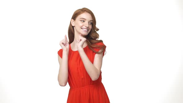 Closeup Caucasian Young Women Portrait in Orange Dress Shy Dancing Over Isolated White Background