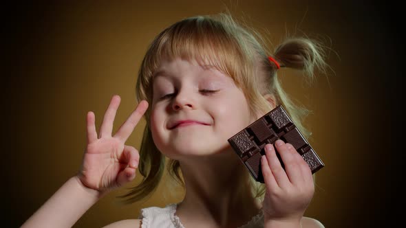 Child Kid Girl with Chocolate Bar Showing Ok Gesture Sign Satisfied Teen Girl Making Faces Smiling