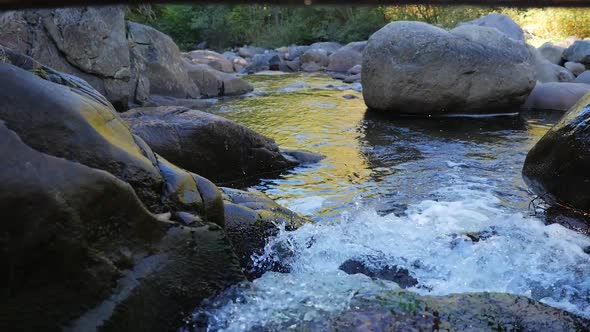 Small Rapids With Many Rocks And A Log On Top