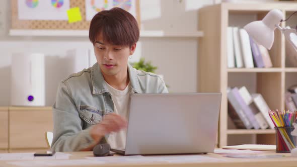 Entrepreneur handsome business asian man wear casual blue shirt working with laptop and talking with