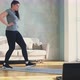 Slim Lady in Sportswear Does Dynamic Lunges Near Laptop - VideoHive Item for Sale
