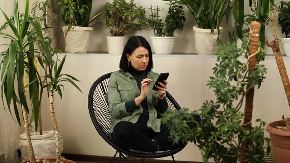 Woman Hold Mobile Phone and Surfing Internet Type Message