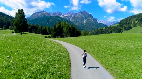 Woman Jogging Outdoors. Italy Dolomites Alps