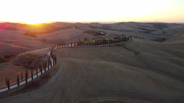 Crete Senesi Tuscan Rolling Hills, Farmhouse, and Cypress Road Aerial View in Tuscany