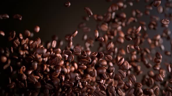 Super Slow Motion Shot of Exploding Premium Coffee Beans on Brown Gradient Background at 1000Fps