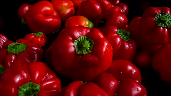 The bell sweet peppers falling into the water. Slow motion.