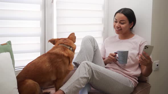 African smiling woman looking at her dog