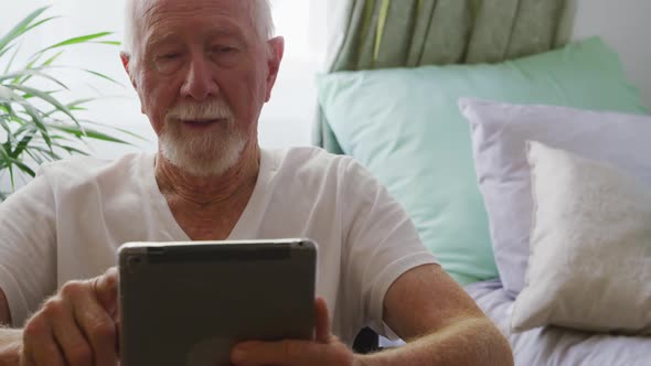 Senior man in social distancing using digital tablet