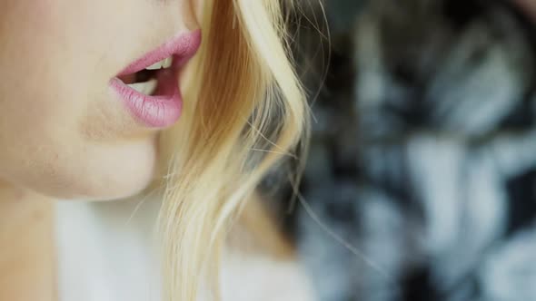 Caucasian Blonde Girl Speaks and Smiles Hairstyle Curls Fall on Her Face