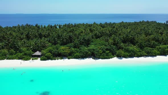 Aerial drone shot tourism of tranquil coast beach trip by blue ocean and white sandy background of a