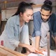 Young Asian couple carpenters man and woman discussing about design of products on laptop. - VideoHive Item for Sale