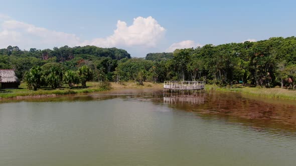 4k aerial panoramic view over the clear waters of the Laguna de los Milagros in Tingo Maria, Peru. B