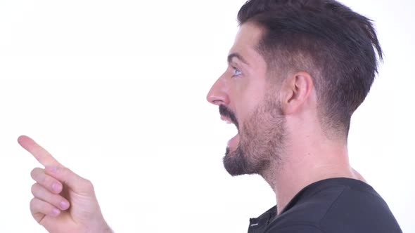 Closeup Profile View of Happy Young Handsome Bearded Man Thinking