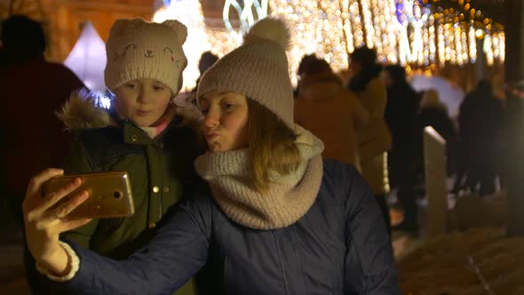 Woman And Girl Take Christmas Selfie