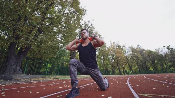 Strong athlete exercising in the stadium