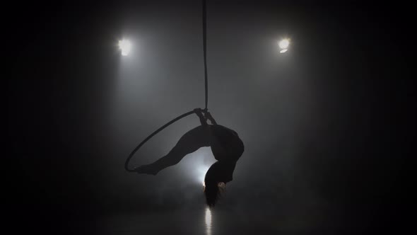 Silhouette Young Caucasian Brunette Sportive Dancer Female Balancer in Beige Leotard Back Lying Hang