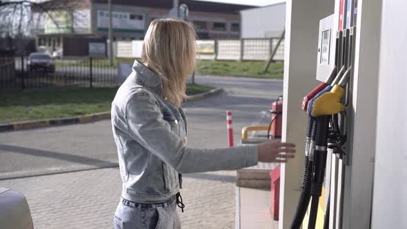 A Person at a Gas Station is Surprised and Indignant at the High Prices of Gasoline