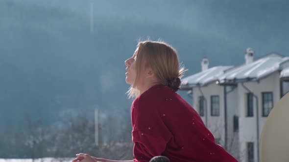 Woman on balcony at morning.