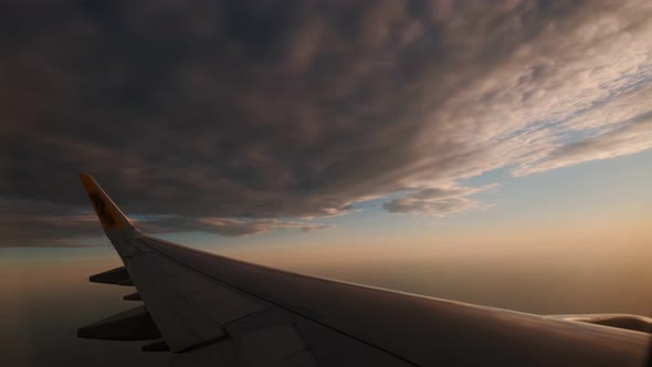 Wing of an Airplane Flying Between the Clouds