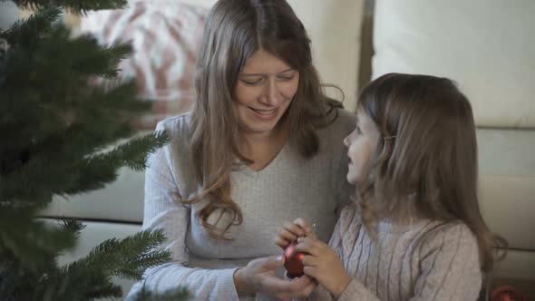 Child Together With Pregnant Woman Mother Dress Up Christmas Tree