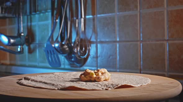 Preparing Low-Calorie Tortilla Wrap With Chicken Breast Stuffing. close up