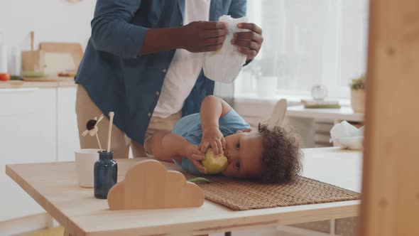 Father Changing Diaper on Toddler